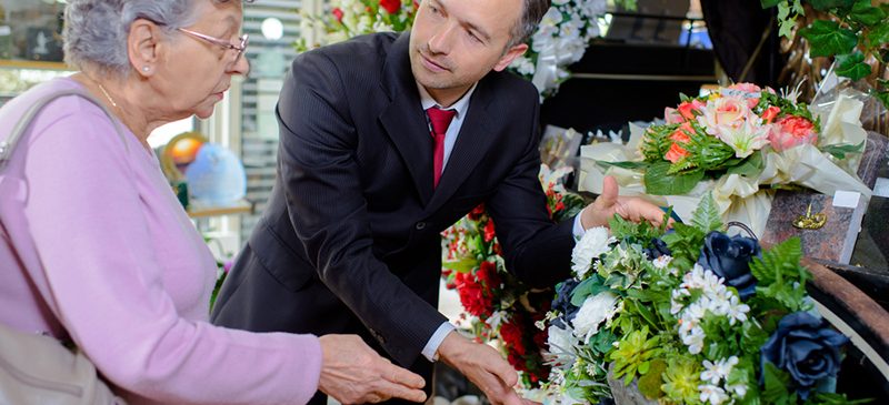 Man helping woman with flowers